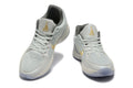 Gray and Gold Nike Kyrie Low Basketball Shoes - product image from the listing.