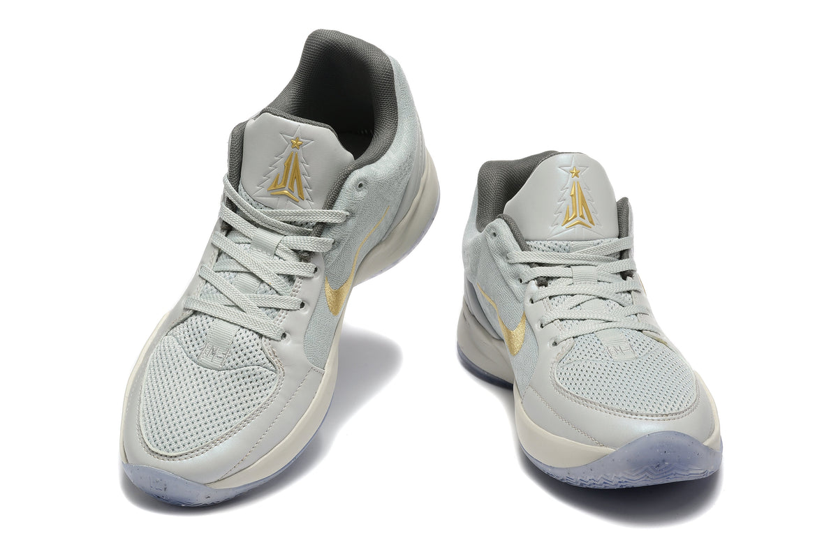 Gray and Gold Nike Kyrie Low Basketball Shoes - product image from the listing.