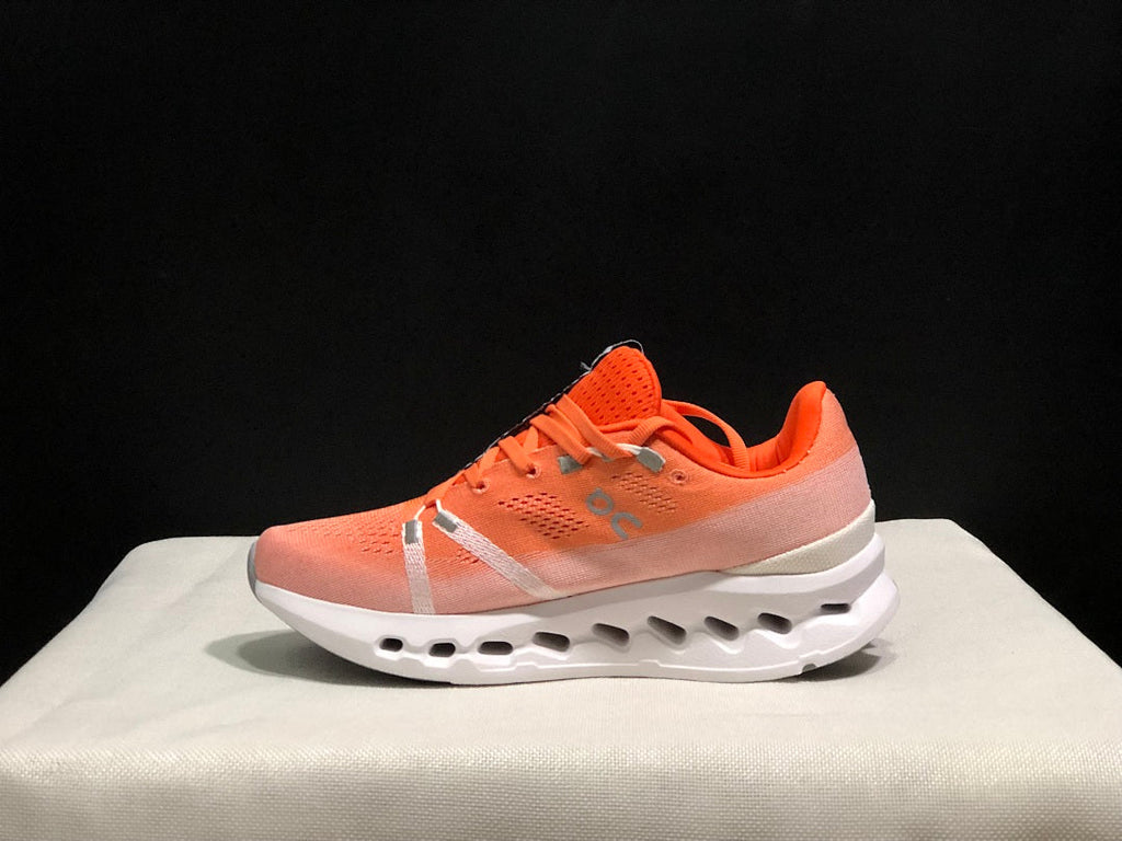 Coral and White On Cloudsurfer Running Shoes - product image from the listing.