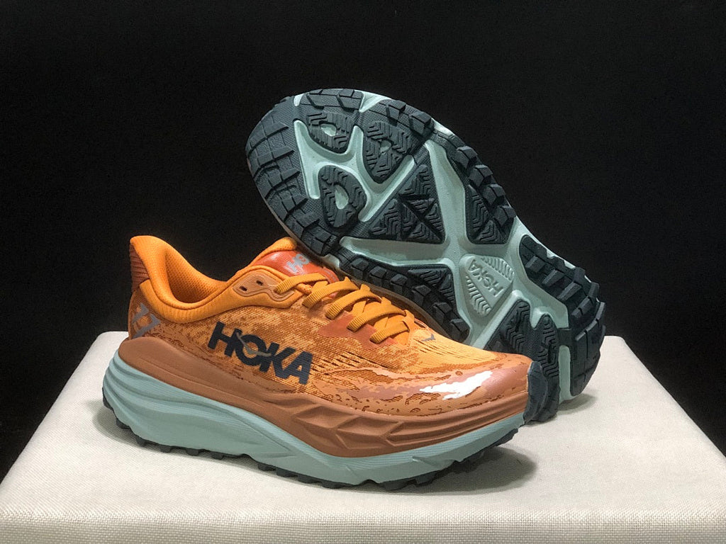 Orange HOKA Stinson 7 Trail Running Shoes - product image from the listing.