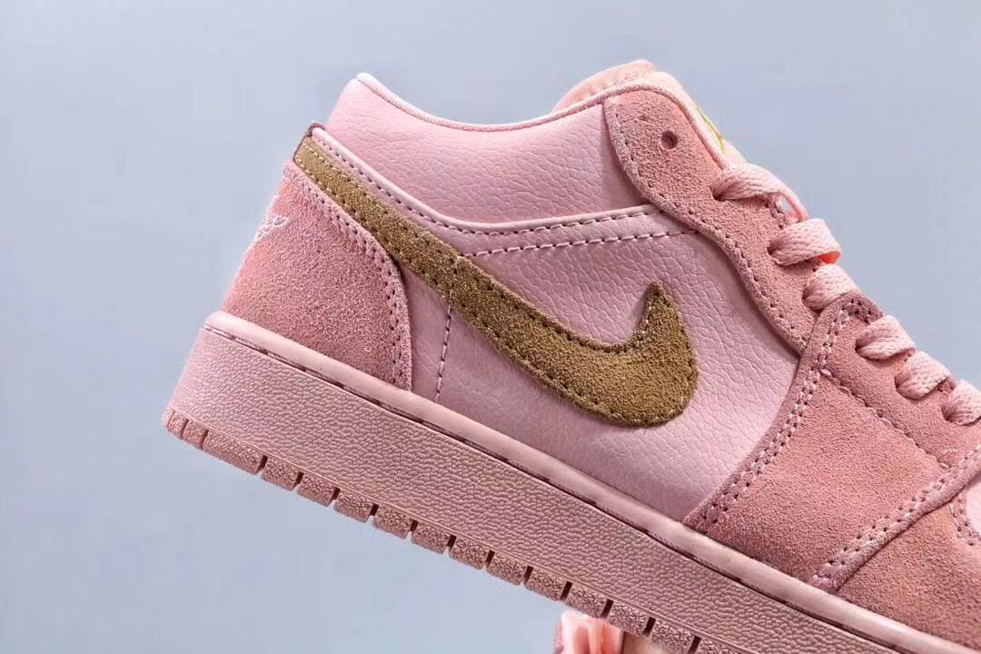 Women's Jordan 1 Low Pink and Gold Sneakers - product image from the listing.