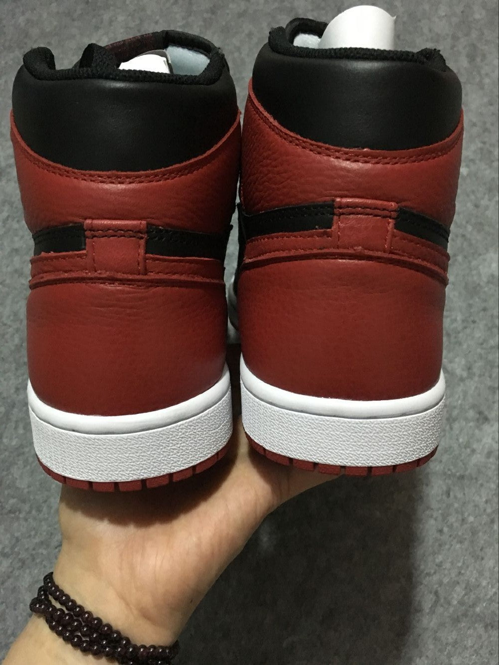 Air Jordan 1 High Sneakers in Black and Red - product image from the listing.