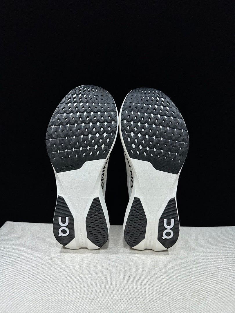 On Cloudboom Strike LS Running Shoes in White Black - product image from the listing.