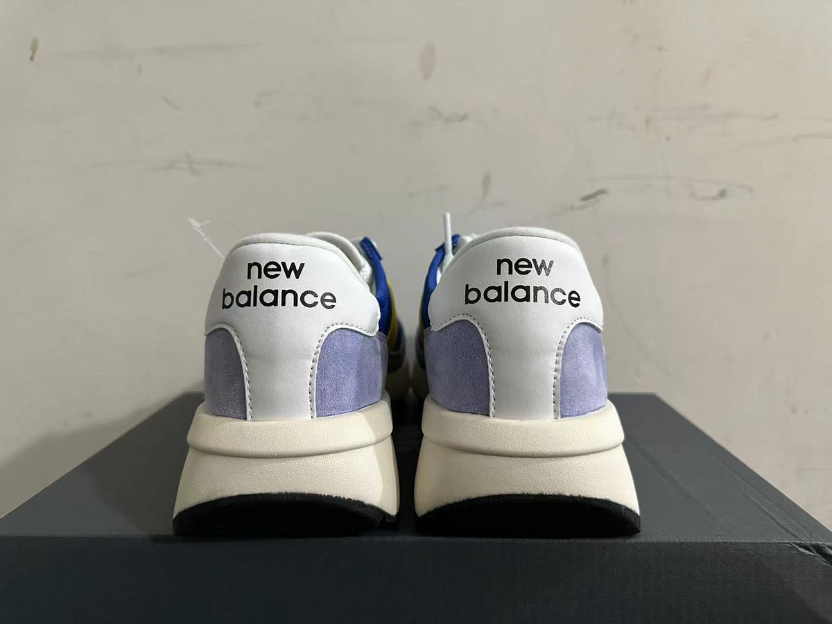 New Balance U370 Sneakers in Blue and Yellow - product image from the listing.