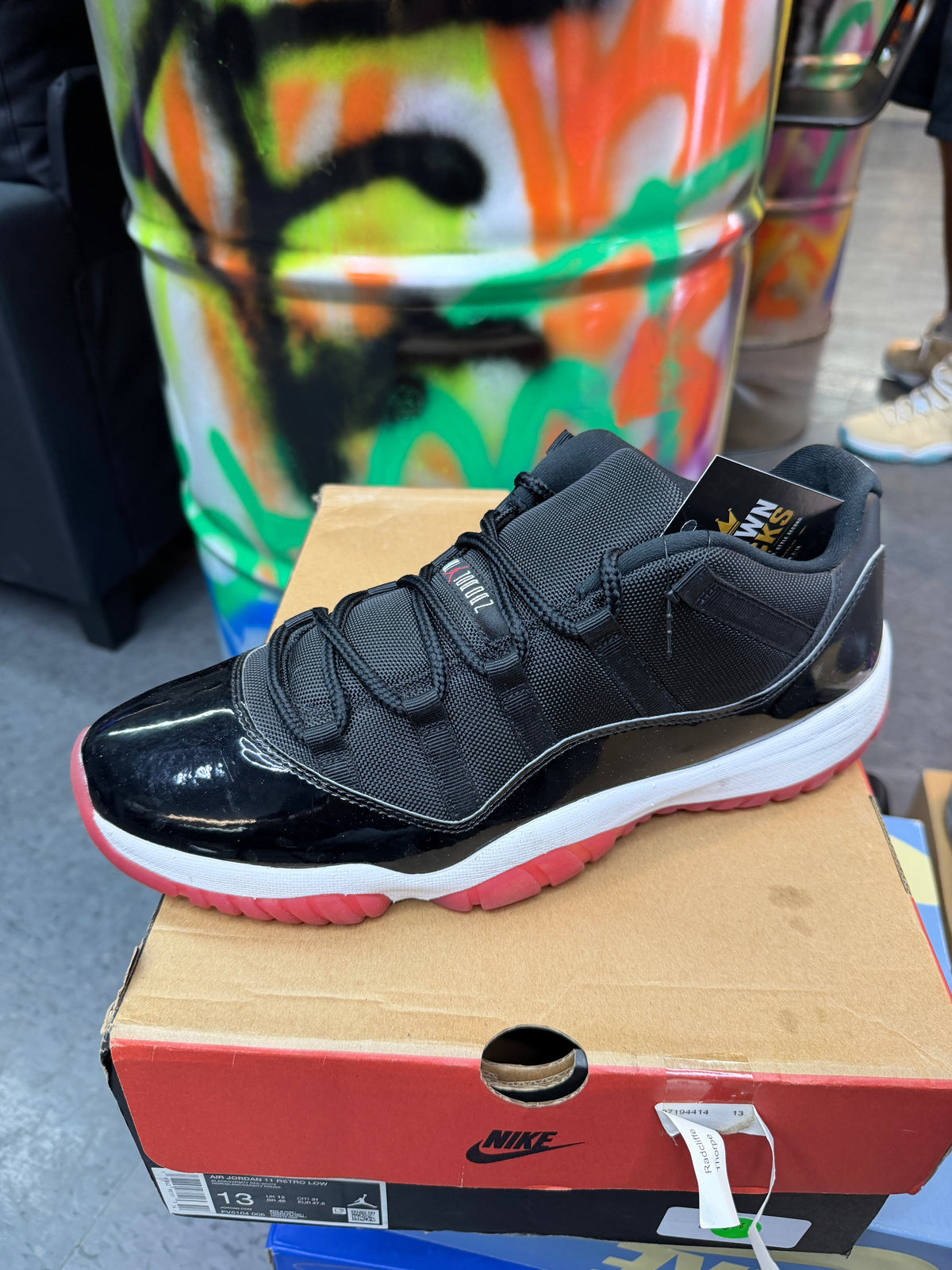 Bred - Jordan 11 Low - product photo shown in the listing for this item.