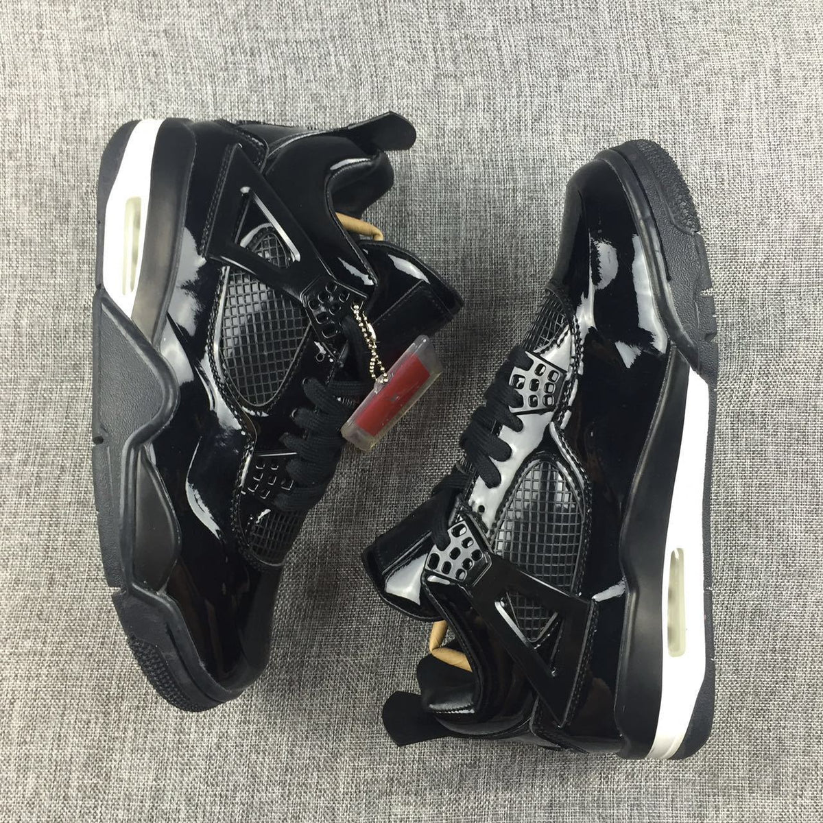 Air Jordan 4 Black Glossy Sneakers - product image from the listing.