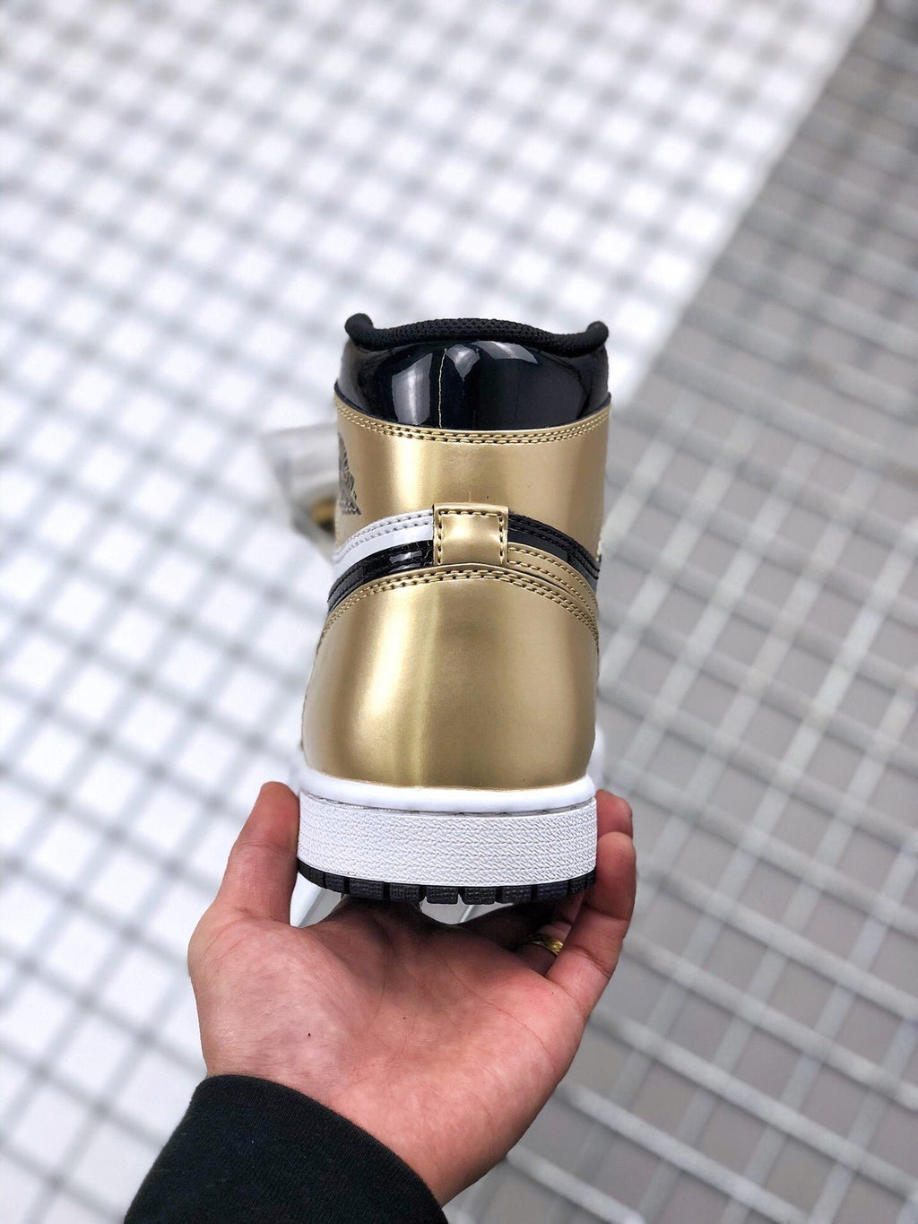 Air Jordan 1 High Gold Toe Sneakers in Black and Gold - product image from the listing.