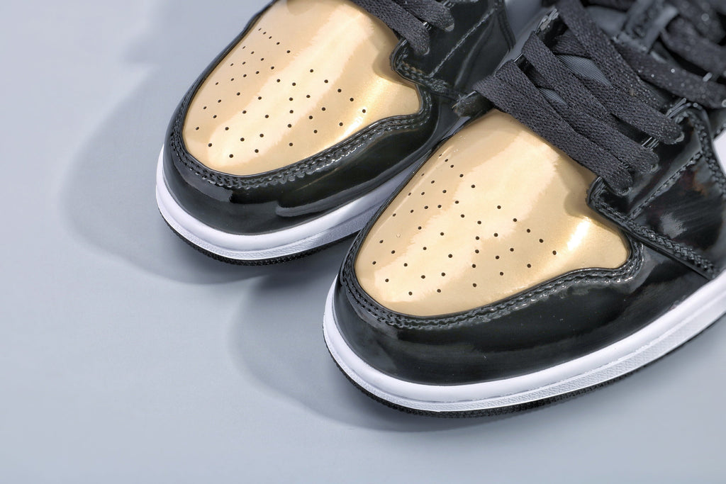 Jordan 1 Low Gold Toe Sneakers in Black and Metallic Gold - product image from the listing.