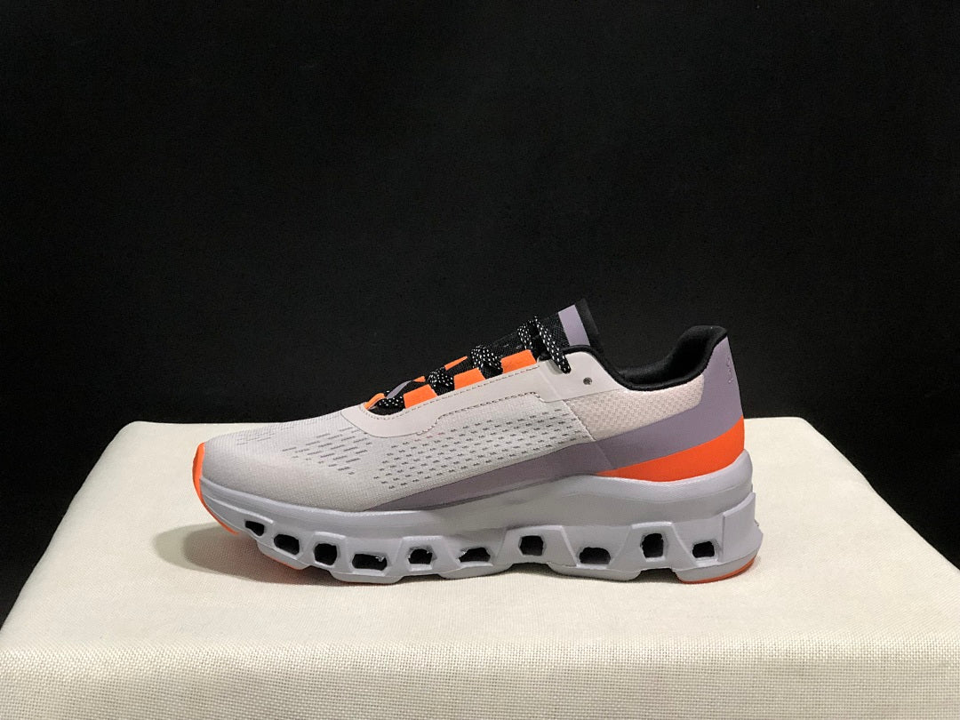 On Cloudmonster Sneakers in Foggy in White and Orange - product image from the listing.