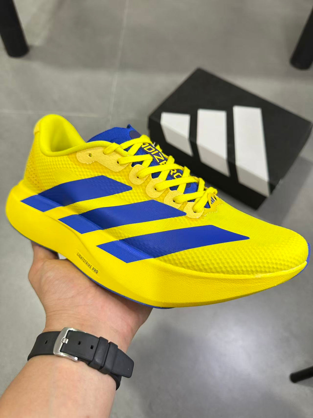 Adidas Lightstrike Pro Running Shoes, in Yellow and Blue - product image from the listing.