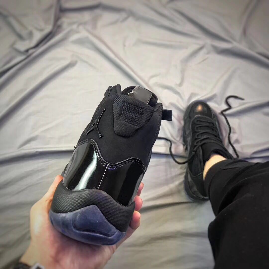 Air Jordan 11 Cap and Gown High-Top Sneakers in Black - product image from the listing.