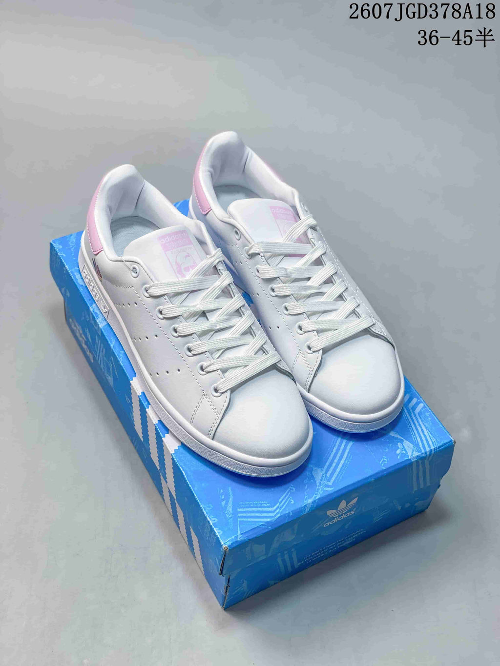 adidas Stan Smith Low-Top Sneakers in White and Pink - product image from the listing.
