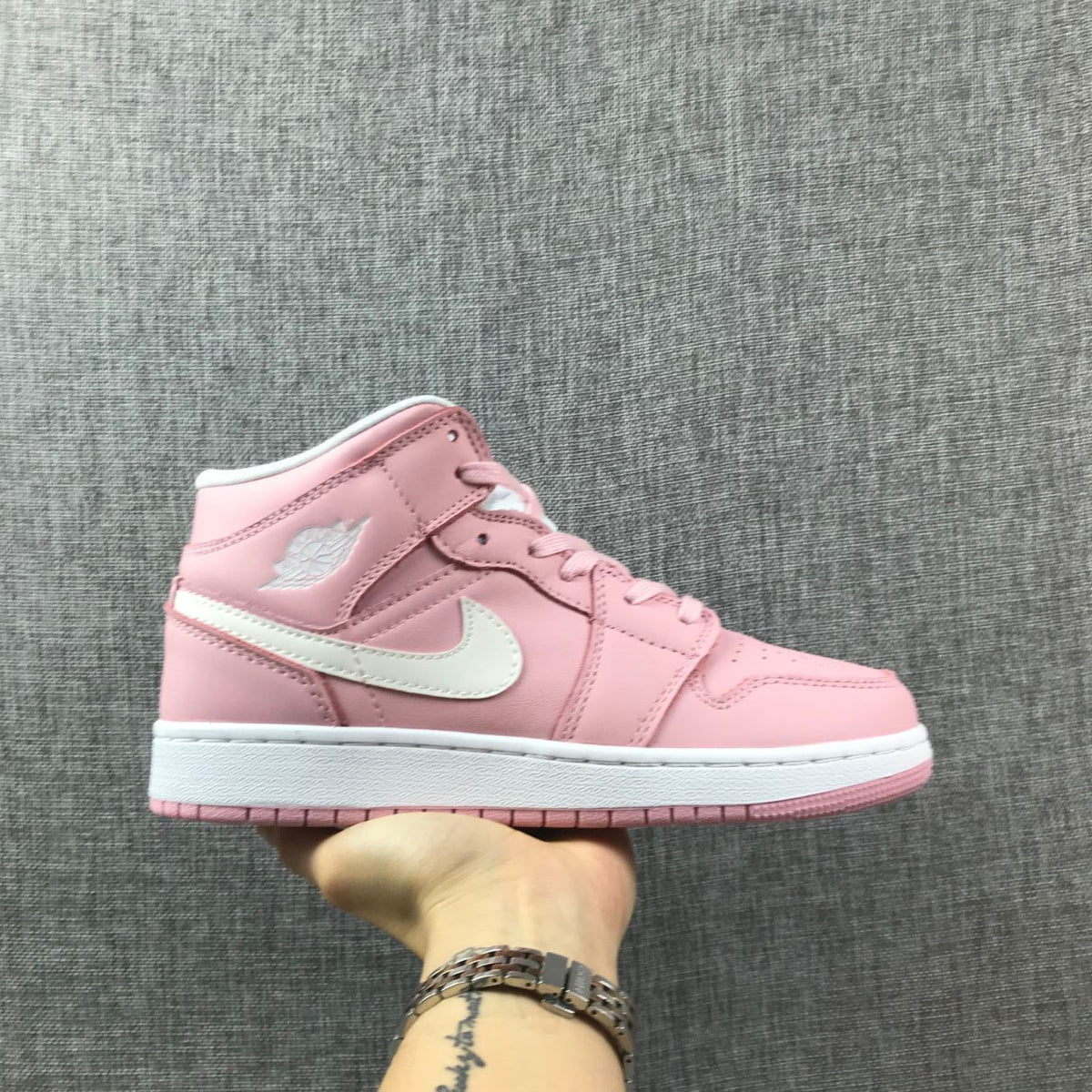 Women's Jordan 1 Mid Pink Sneakers 555112-100 - product image from the listing.