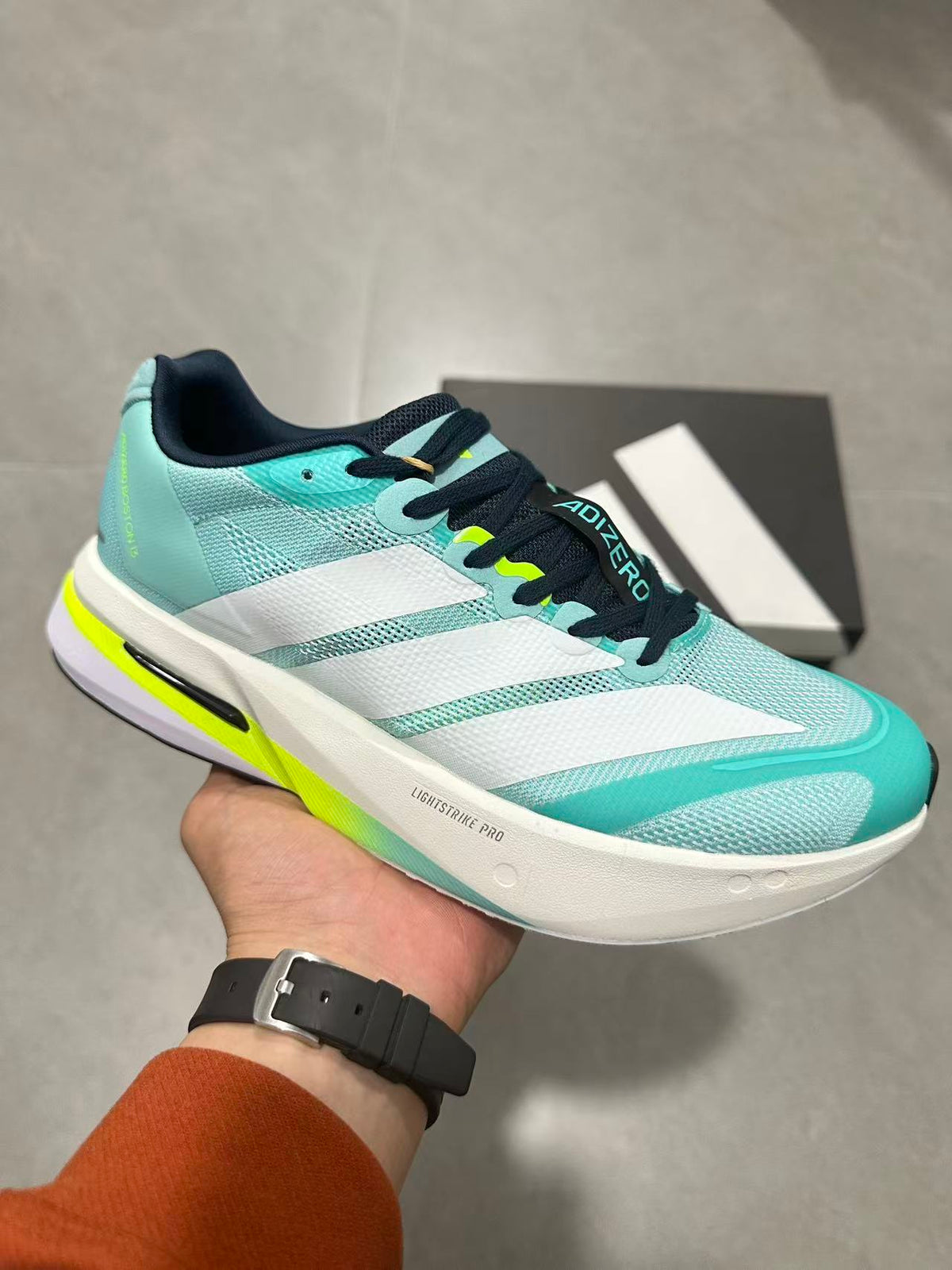 adidas Adizero Lightstrike Pro Running Shoes, in Mint and Black - product image from the listing.