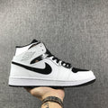 Air Jordan 1 Mid Sneakers in White and Black - product image from the listing.