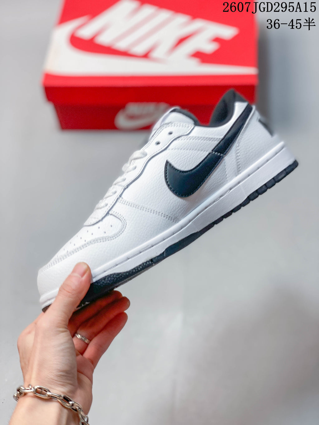 Nike SB Dunk Low Pro Sneakers in White Black 2607JGD295A15 - product image from the listing.