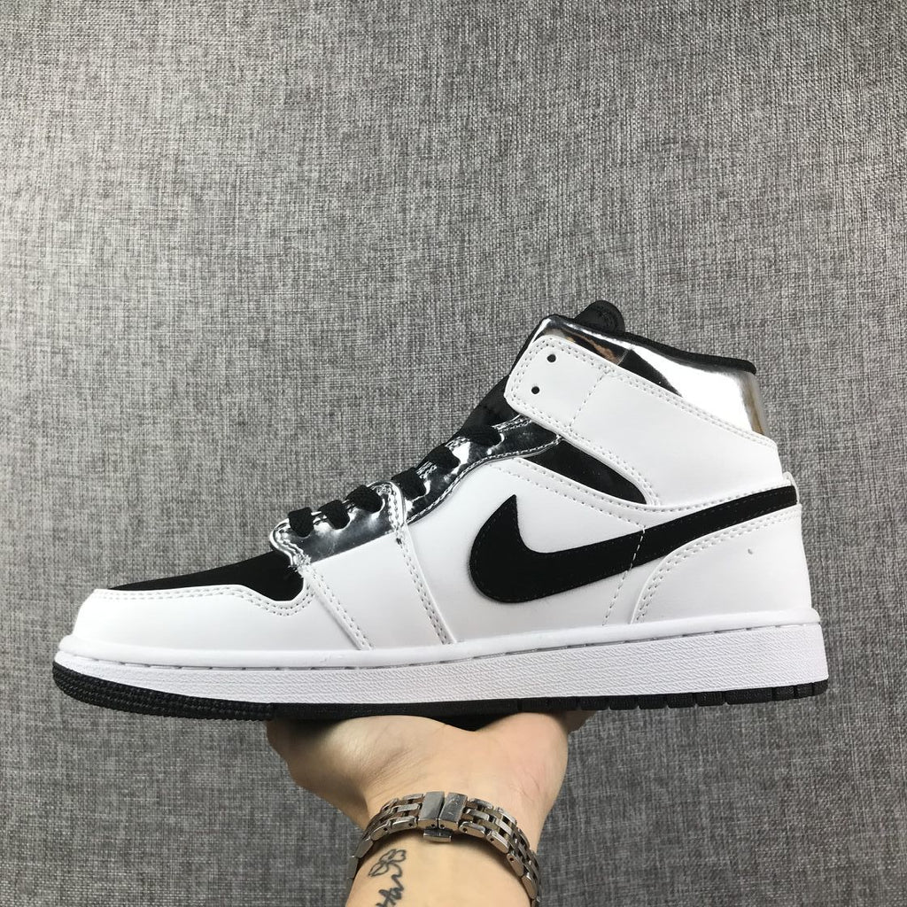 Air Jordan 1 Mid Sneakers in White and Black - product image from the listing.