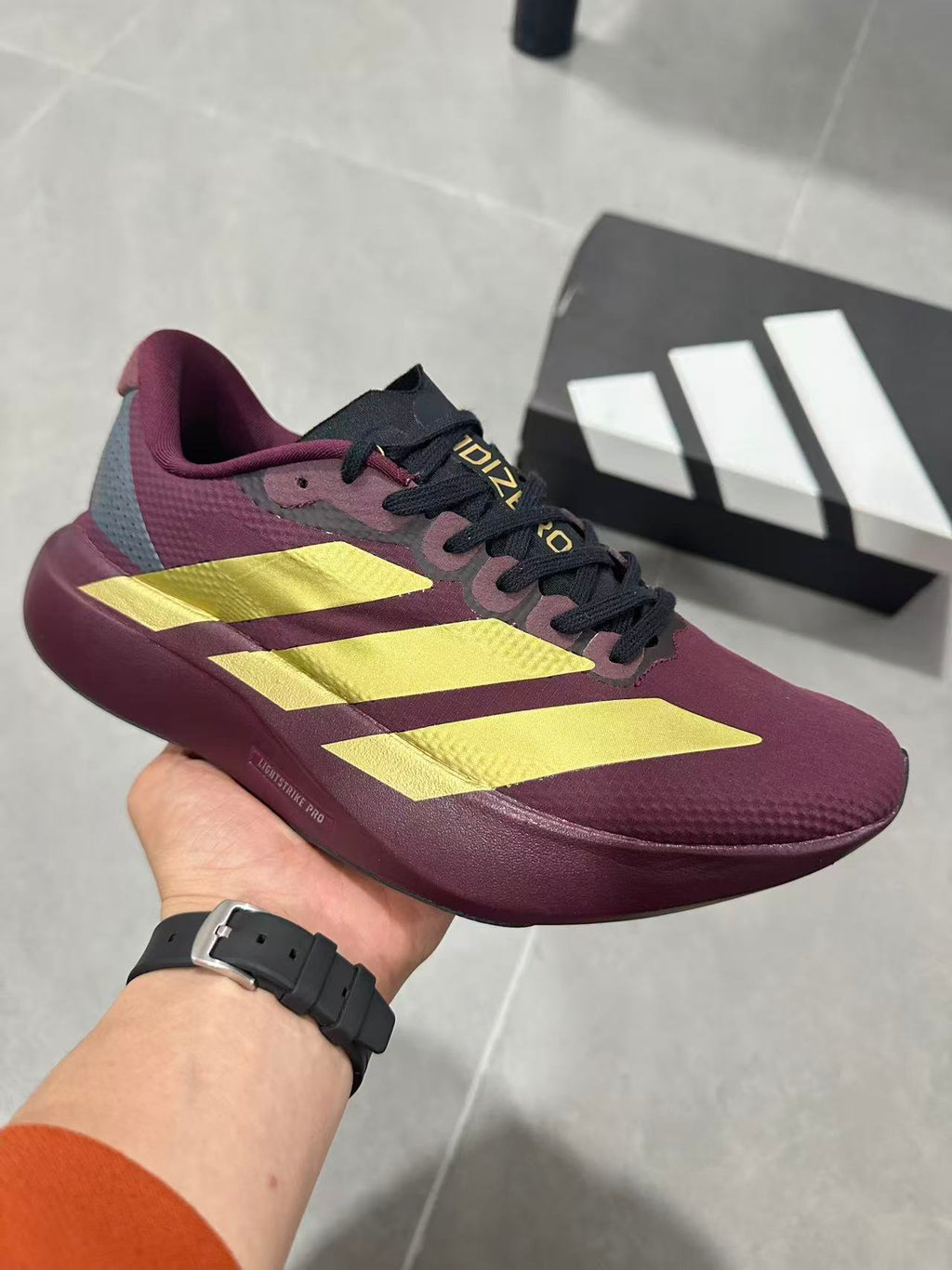 Adidas Lightstrike Pro Running Shoes in Burgundy Gold JQ4443 - product image from the listing.