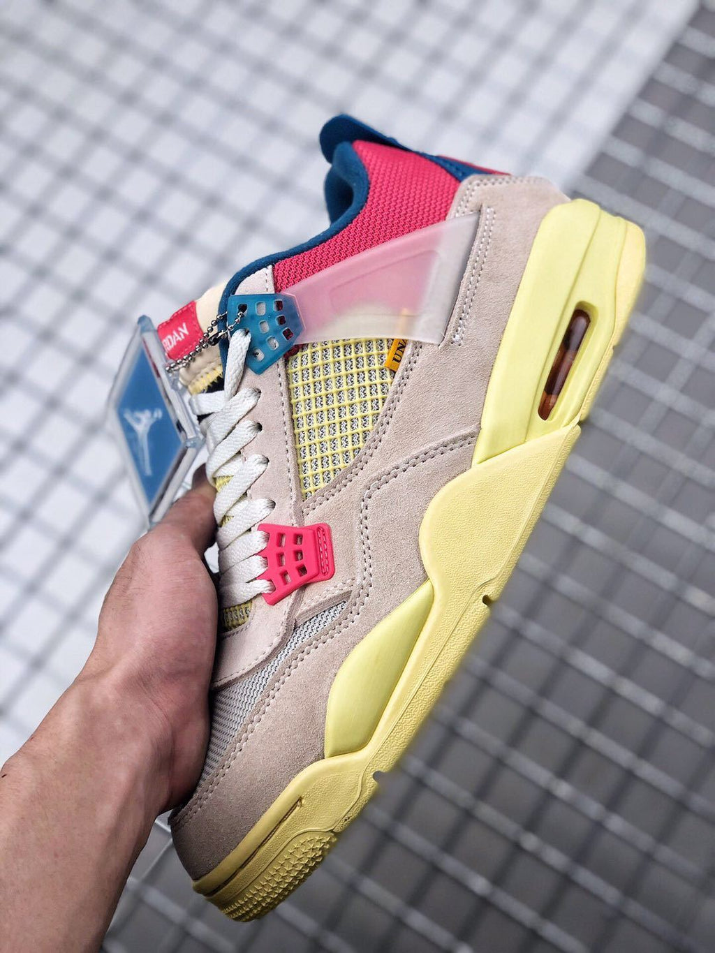 Union x Air Jordan 4 Sneakers in Pink Beige Navy Yellow - product image from the listing.