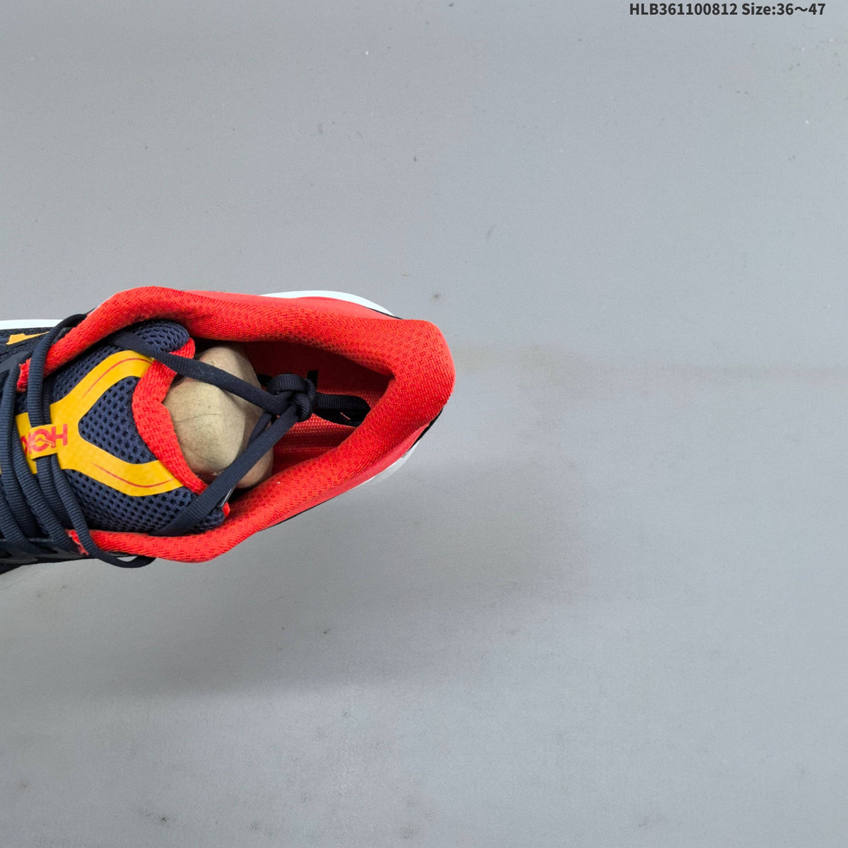 HOKA Bondi 9 Running Shoes in Navy, in Red and Yellow - product image from the listing.