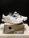 On Cloud X 4 Sneakers in Ivory and Black - product image from the listing.
