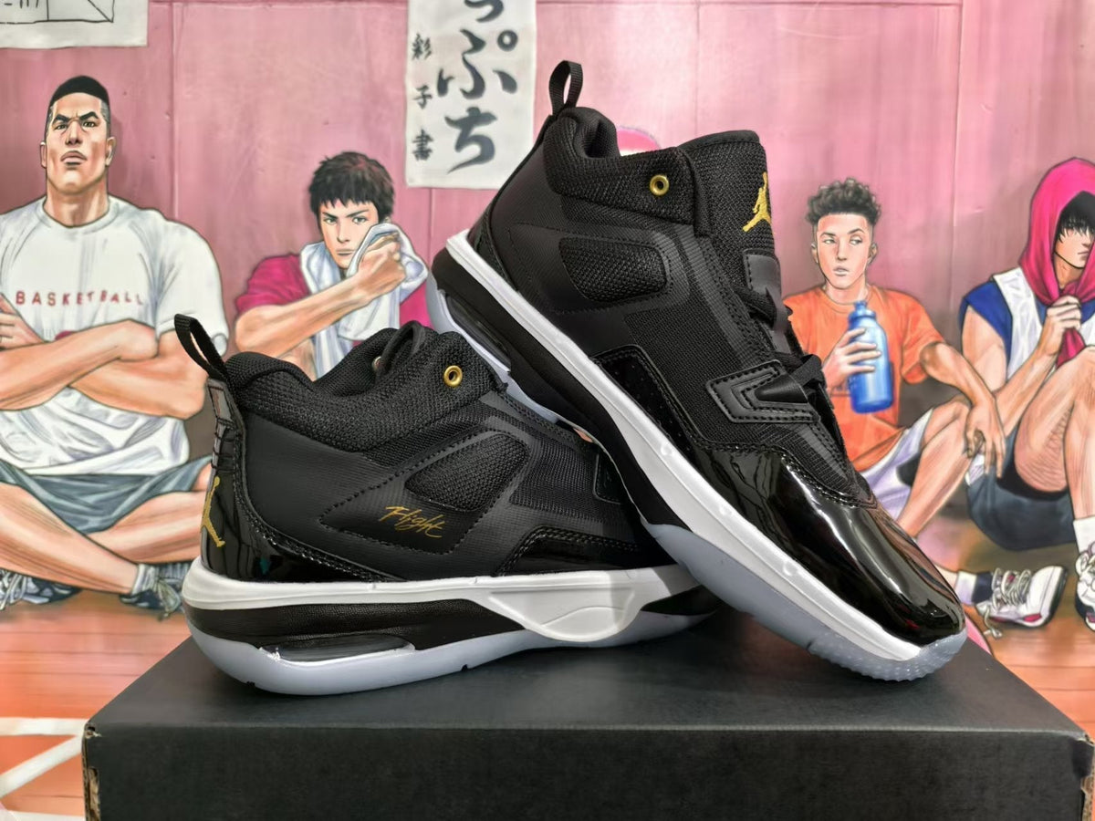 Jordan Black and Gold High-Cut Basketball Sneakers - product image from the listing.