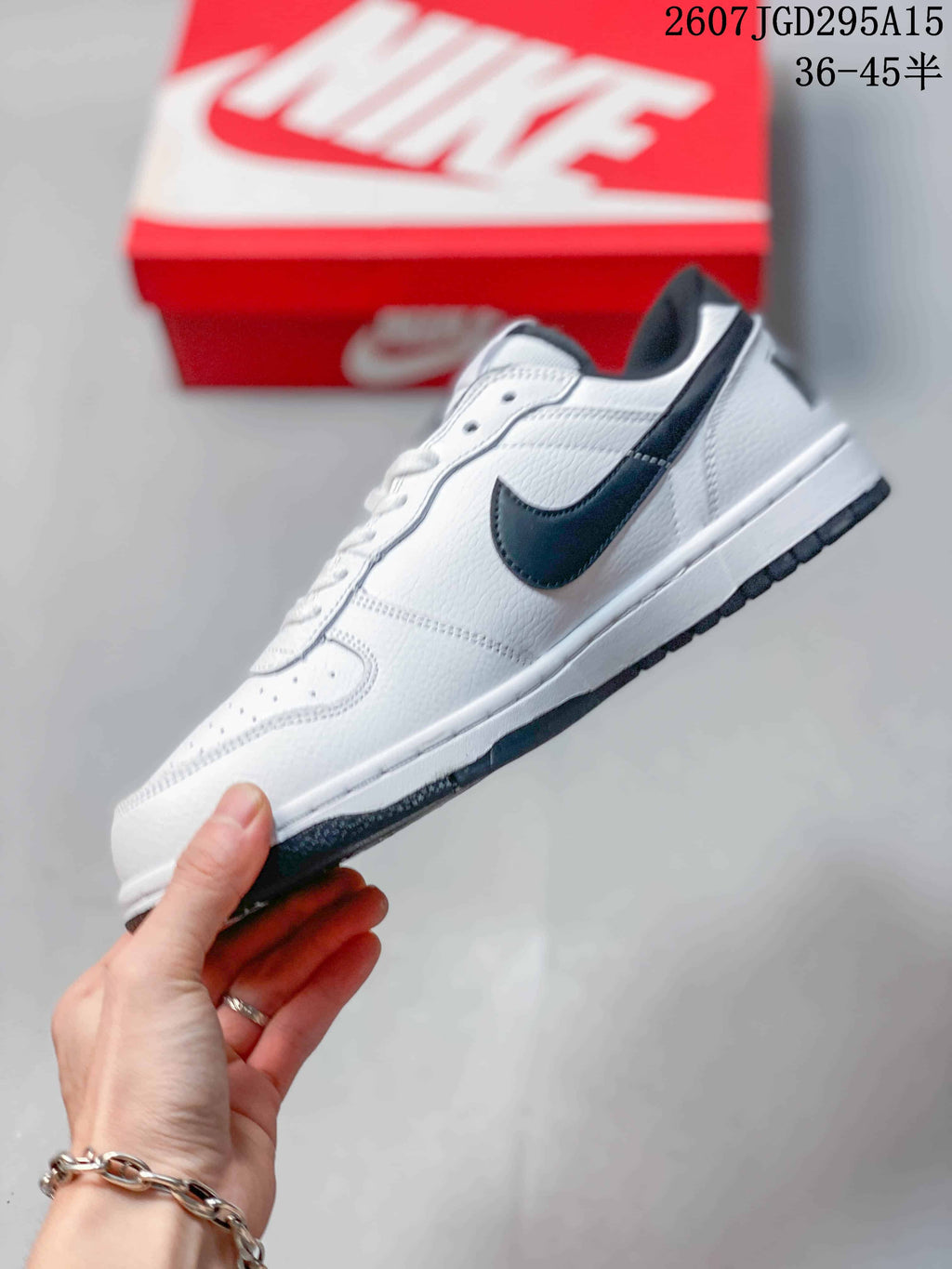 Nike SB Dunk Low Pro Sneakers in White Black 2607TGD295A15 - product image from the listing.