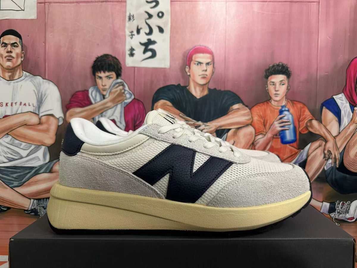 New Balance U370 Sneakers in Off-White and Black - product image from the listing.