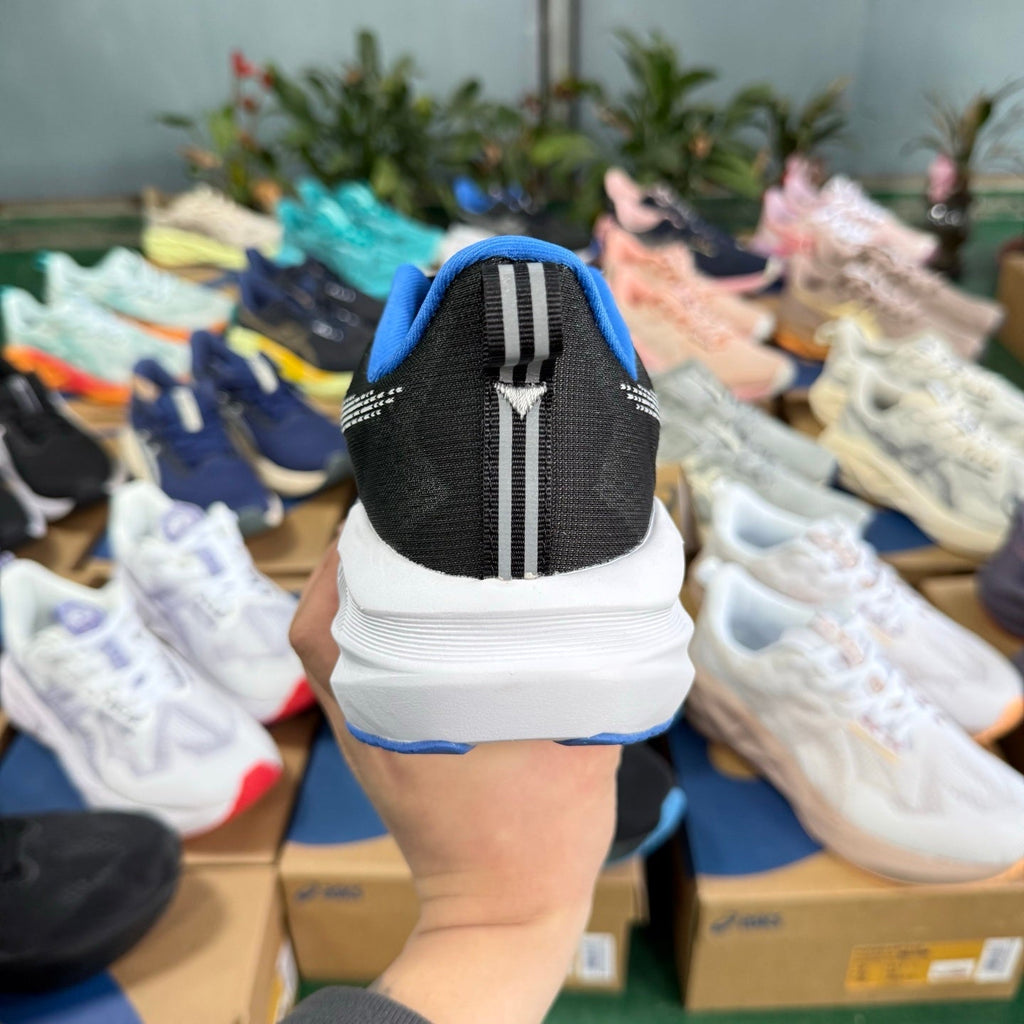 ASICS Novablast 5 LE Running Shoes in Black Blue - product image from the listing.