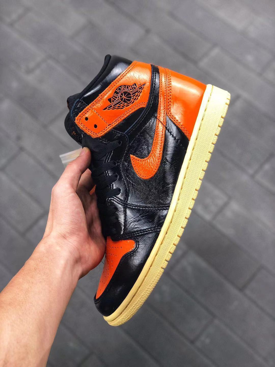 Air Jordan 1 Retro High OG Sneakers in Black and Orange - product image from the listing.