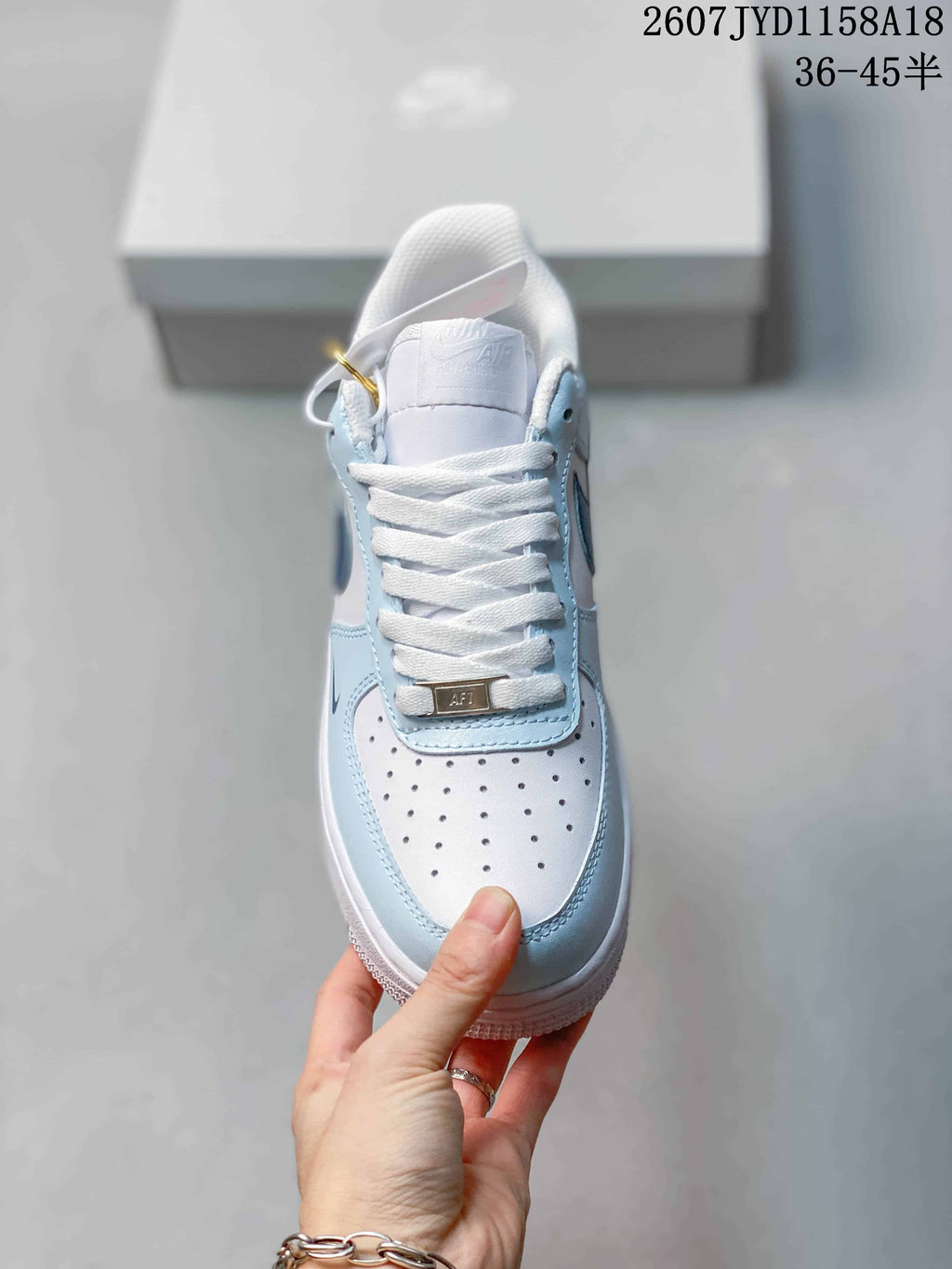 Nike Air Force 1 '07 Low Sneakers, in White and Light Blue - product image from the listing.