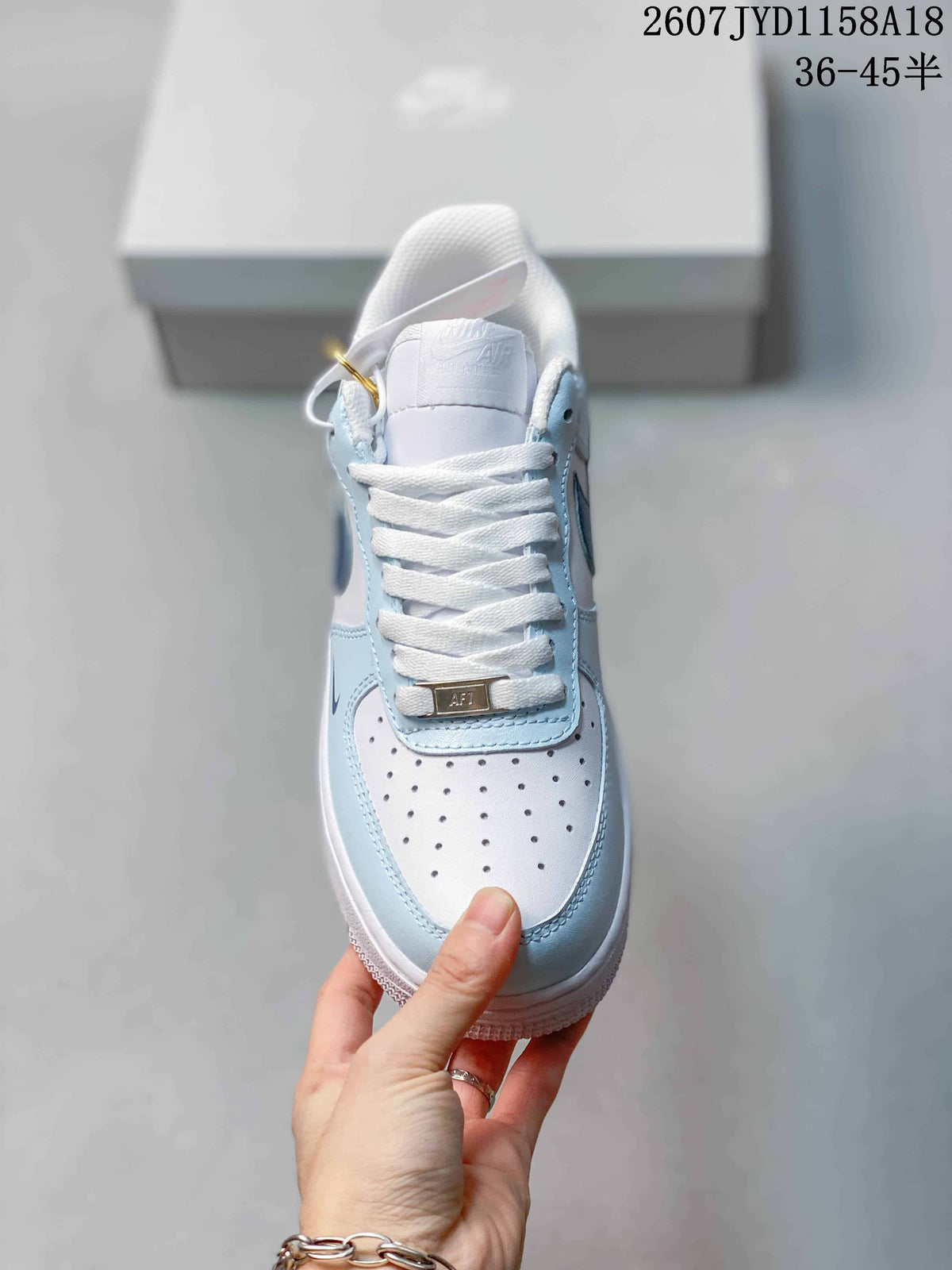 Nike Air Force 1 '07 Low Sneakers, in White and Light Blue - product image from the listing.