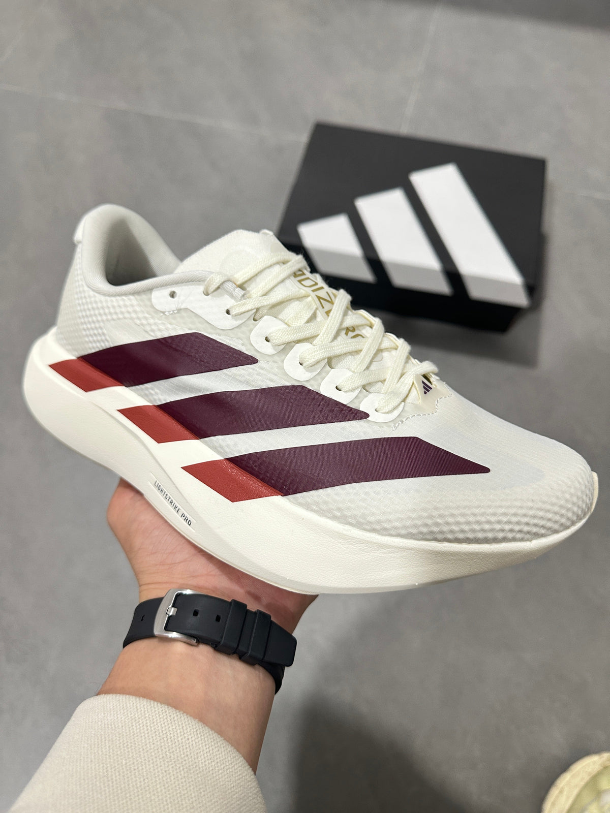 White and Burgundy Adidas Lightstrike Pro Running Shoes - product image from the listing.