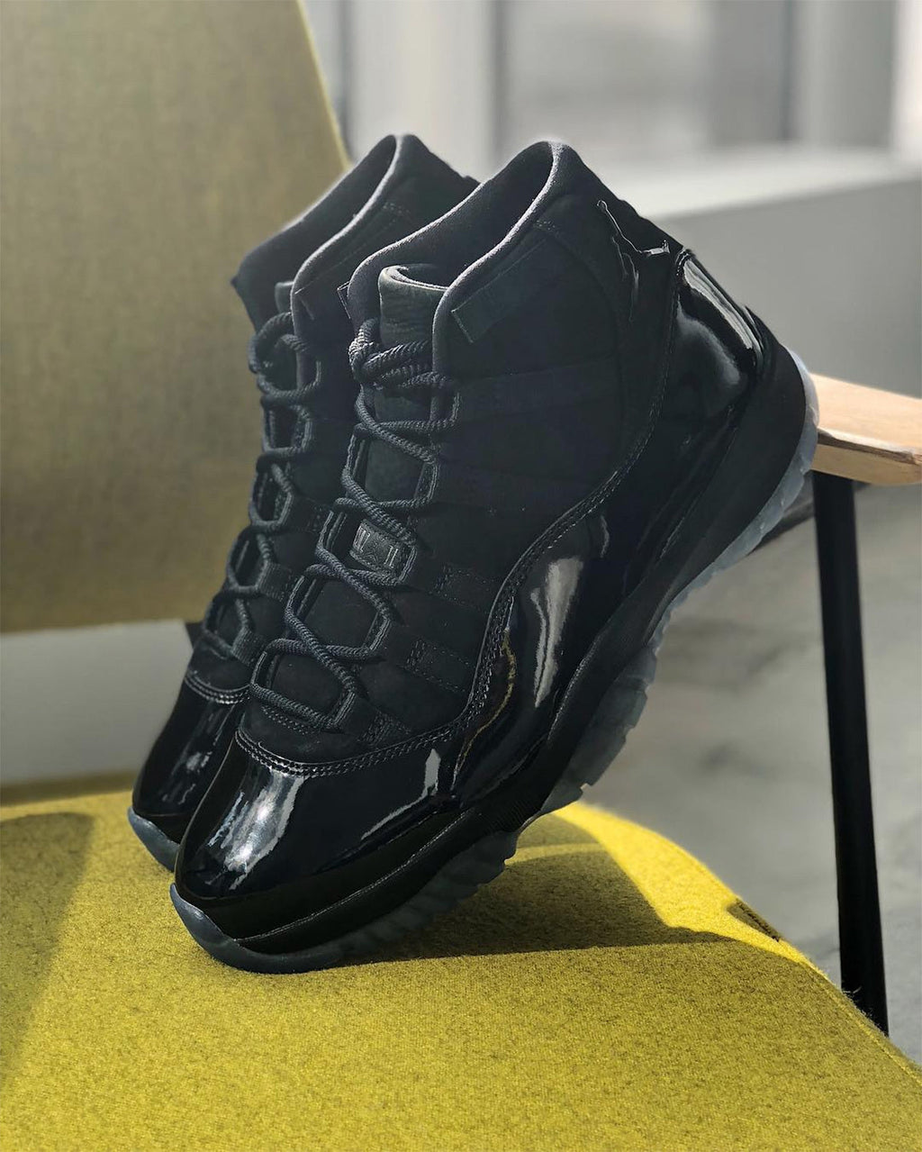 Air Jordan 11 Cap and Gown High-Top Sneakers in Black - product image from the listing.