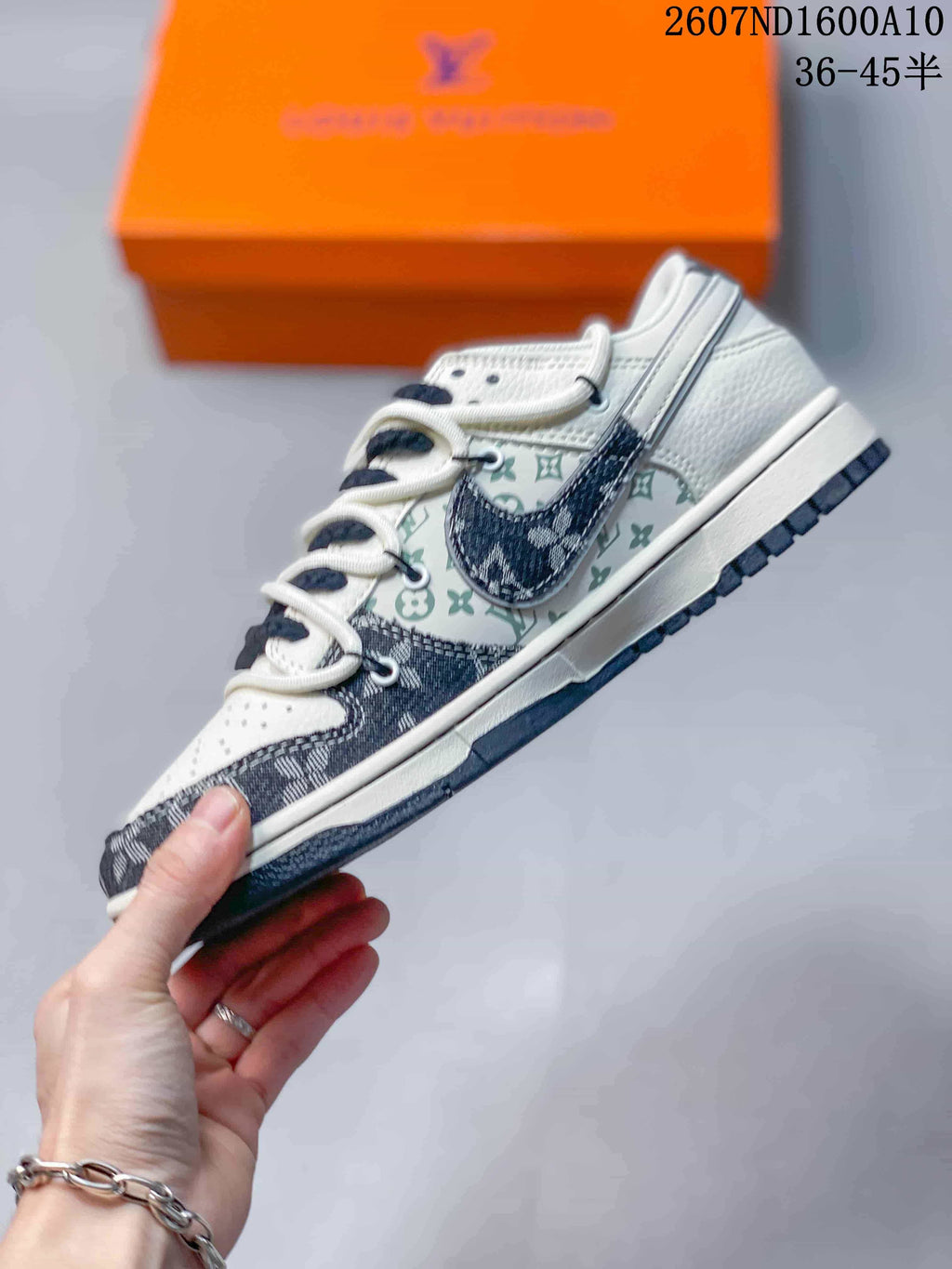 Nike SB Dunk Low Low-Top Sneakers in White and Navy - product image from the listing.