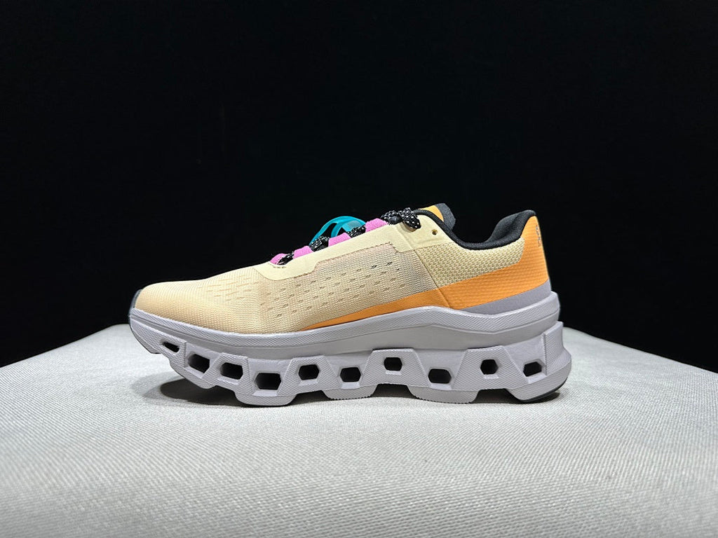 On Cloudmonster Running Shoes, in Pale Yellow and Orange - product image from the listing.