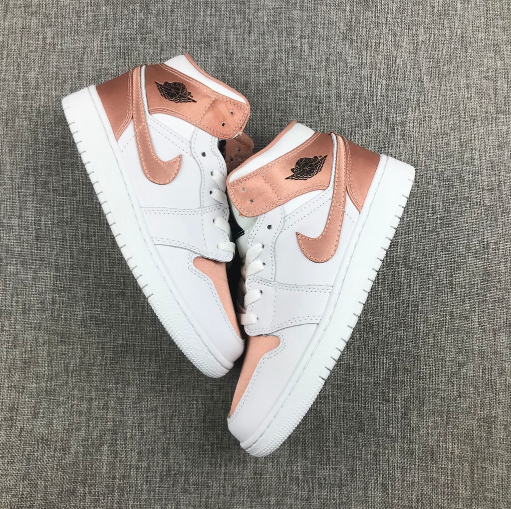 Women's Jordan 1 Mid Rose Gold Silk Sneakers 555112-190 - product image from the listing.