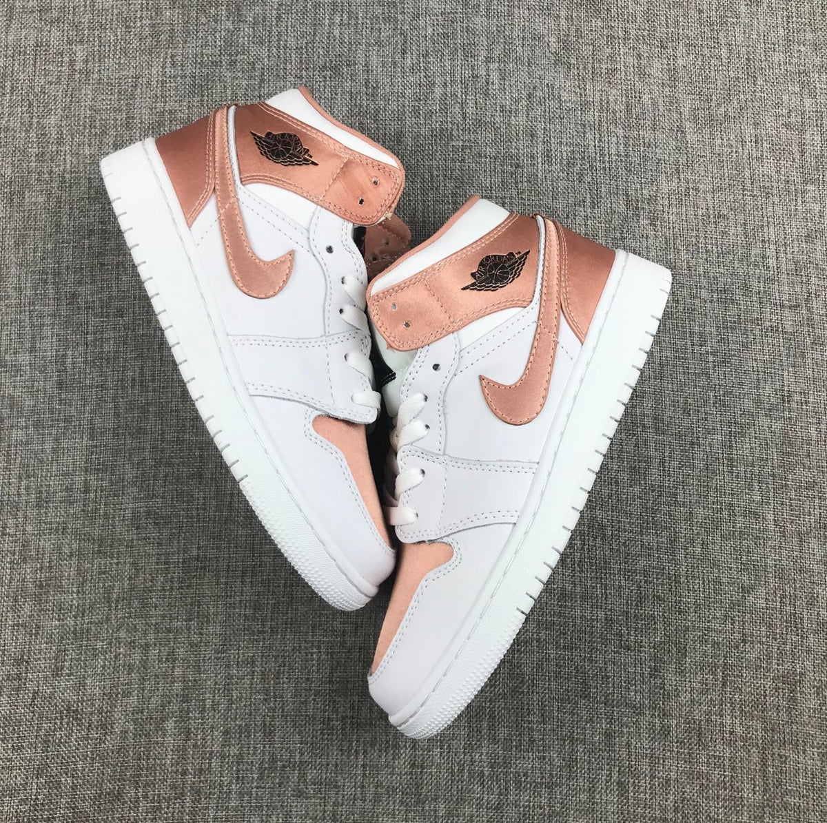Women's Jordan 1 Mid Rose Gold Silk Sneakers 555112-190 - product image from the listing.