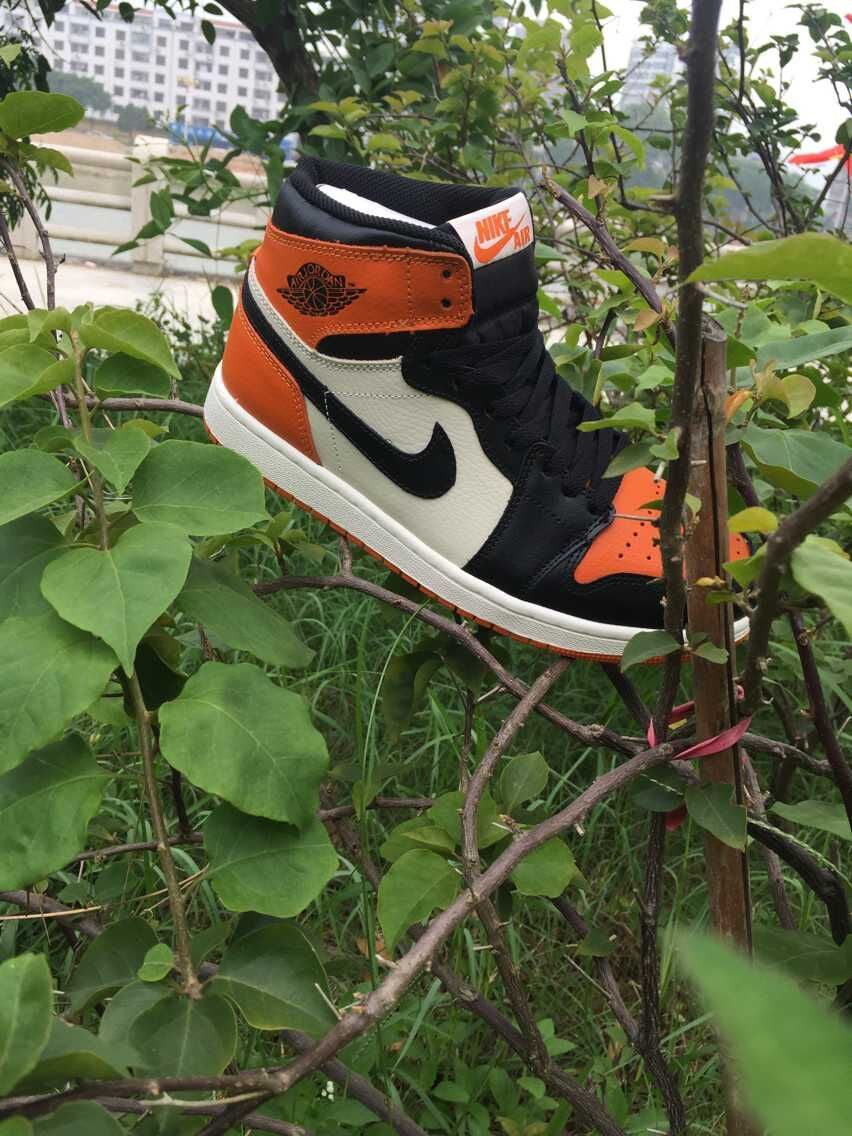 Jordan 1 High Sneakers in Black, in White and Orange - product image from the listing.