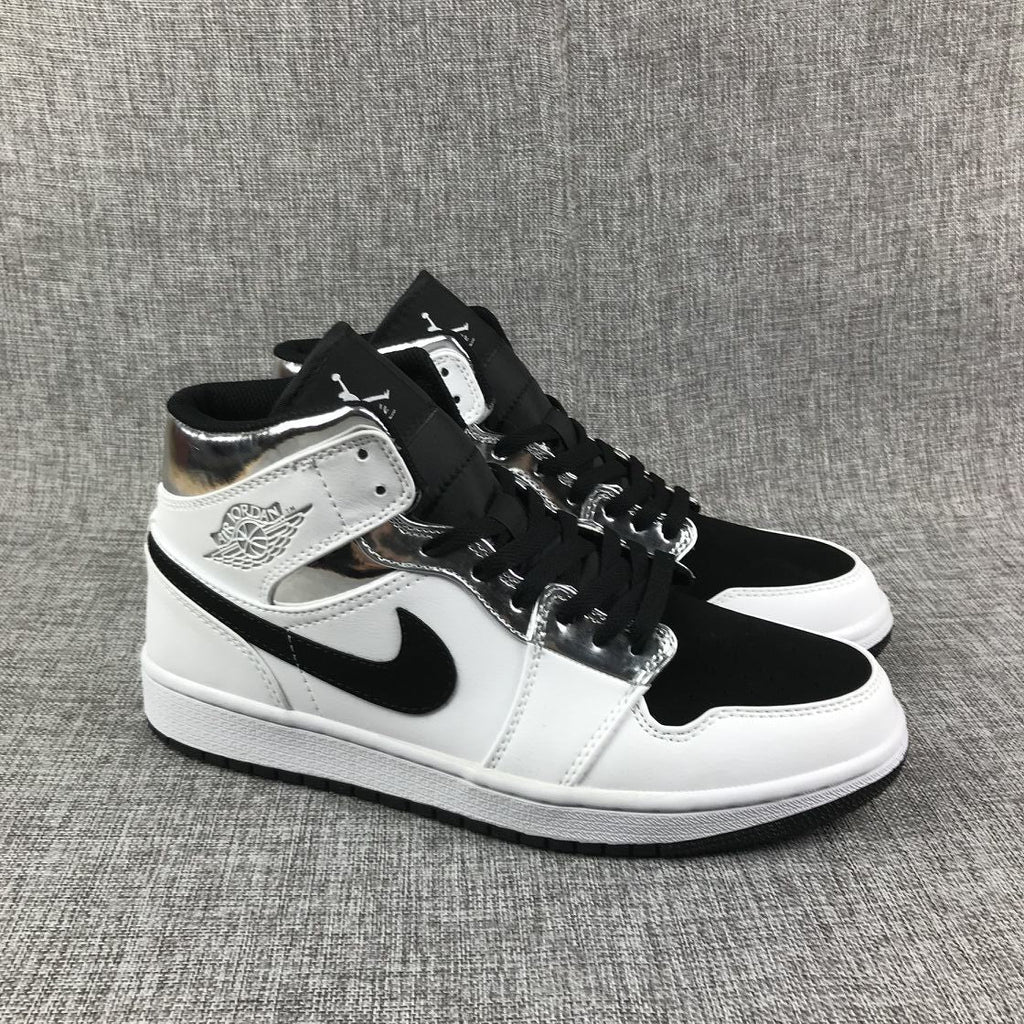 Air Jordan 1 Mid Sneakers in White and Black - product image from the listing.