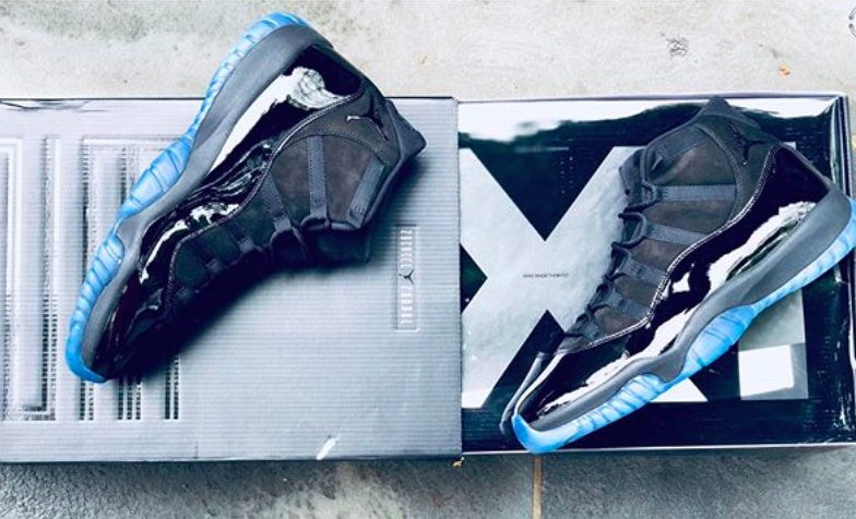 Air Jordan 11 Cap and Gown High-Top Sneakers in Black - product image from the listing.