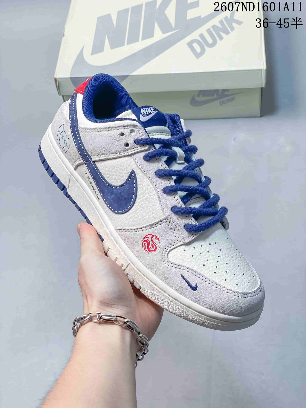 Nike SB Dunk Low Sneakers in White and Blue 2607ND1601A11 - product image from the listing.