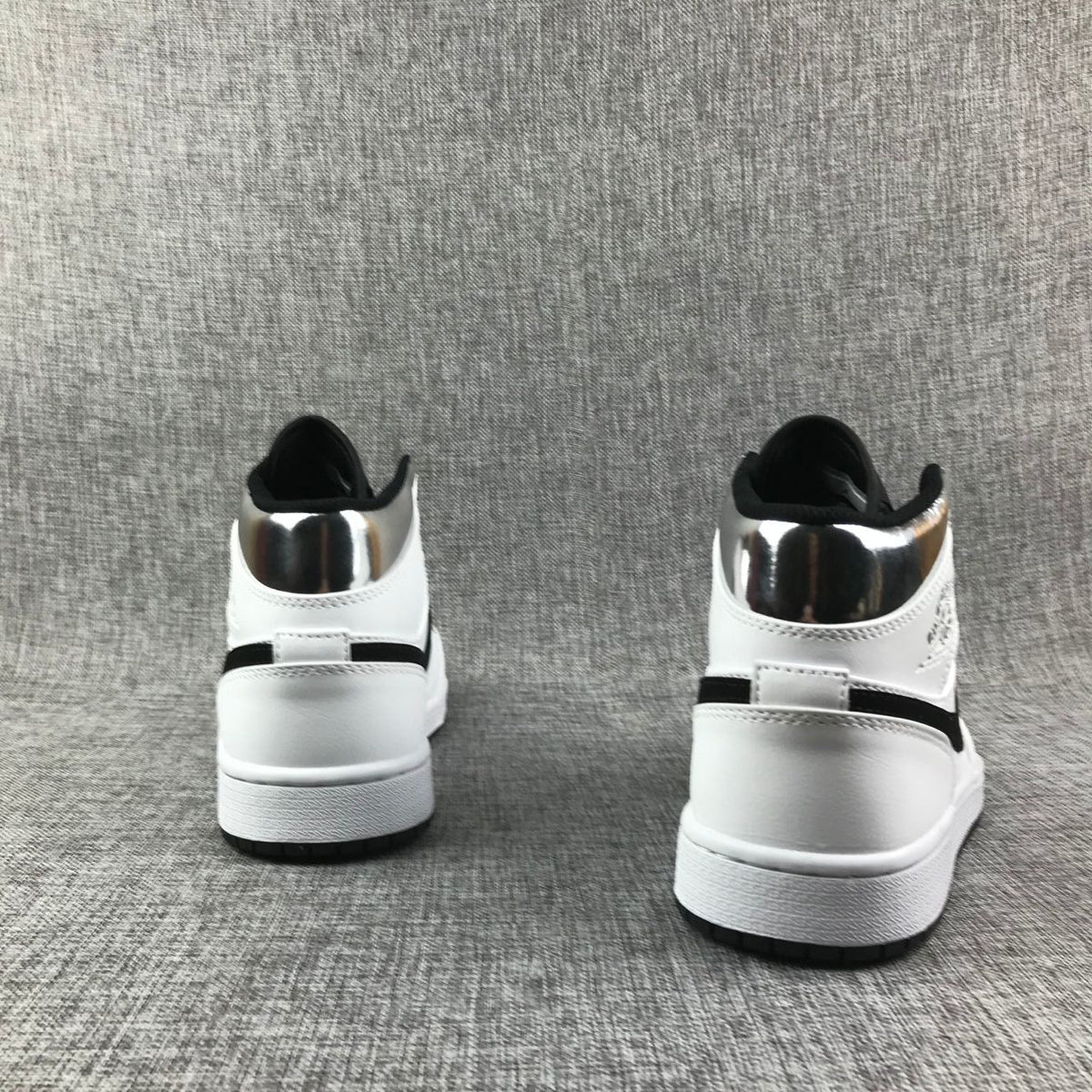 Air Jordan 1 Mid Sneakers in White and Black - product image from the listing.