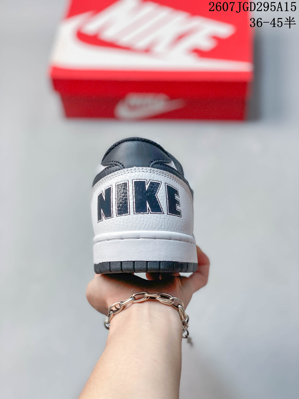 Nike SB Dunk Low Pro Sneakers in White Black 2607JGD295A15 - product image from the listing.
