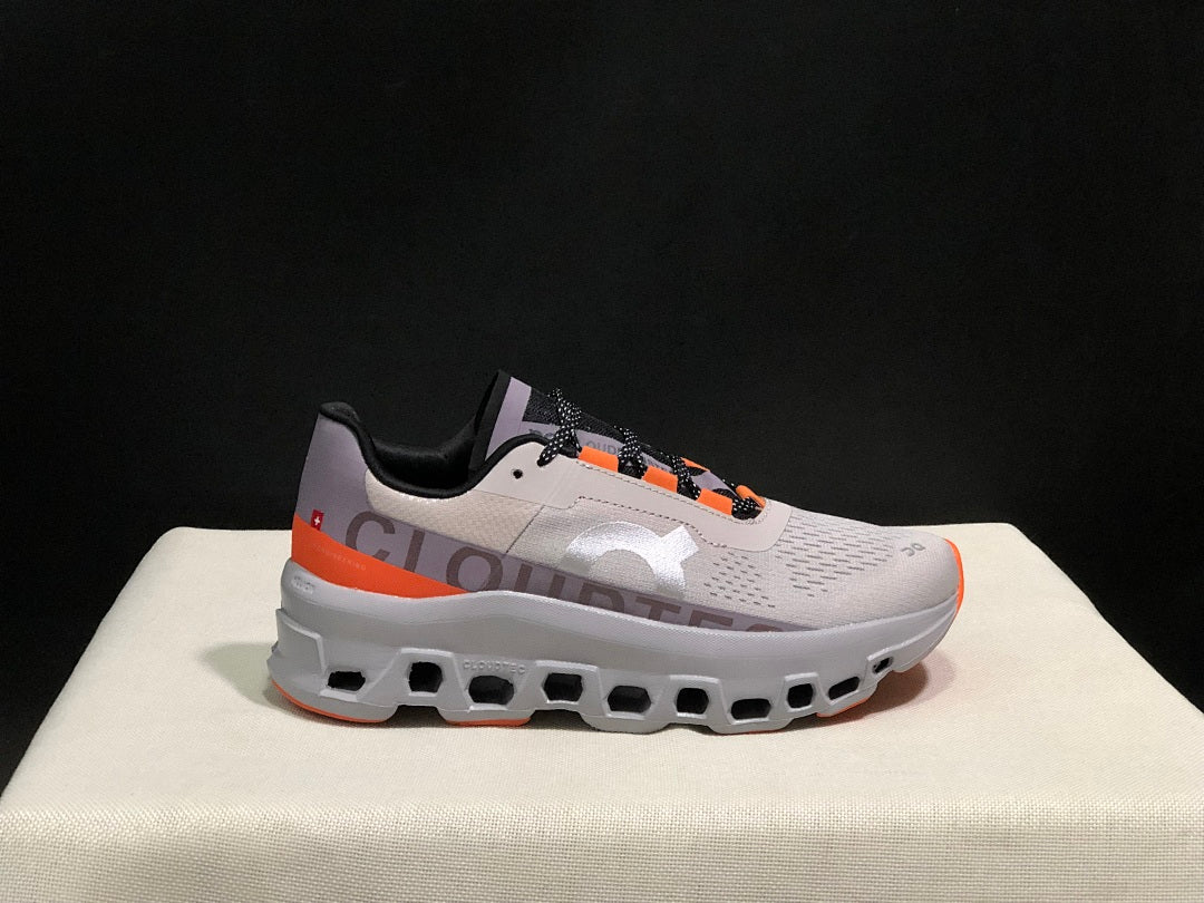 On Cloudmonster Sneakers in Foggy in White and Orange - product image from the listing.