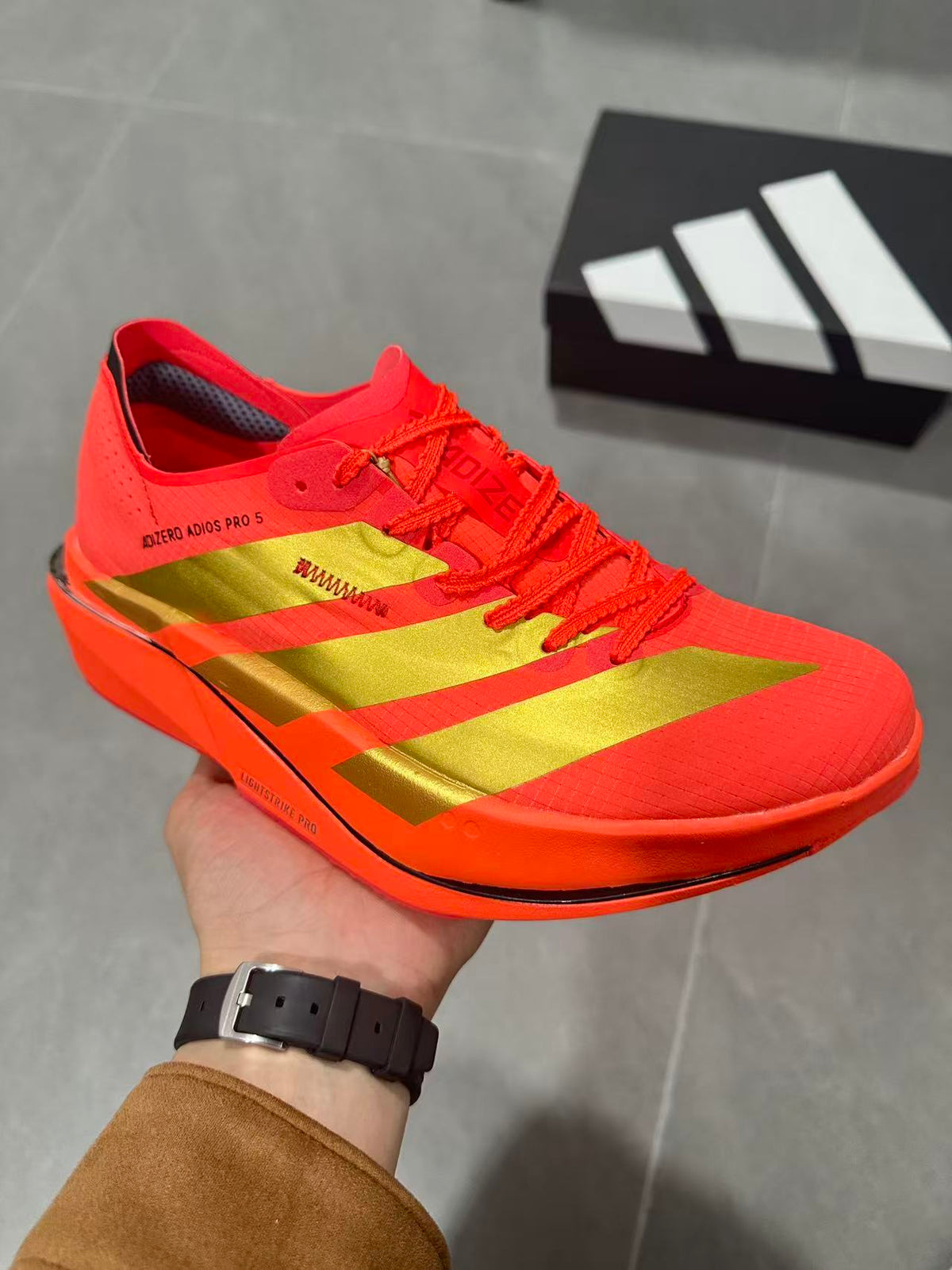 Adidas Adizero Adios Pro 5 Running Shoes, in Red and Lime - product image from the listing.