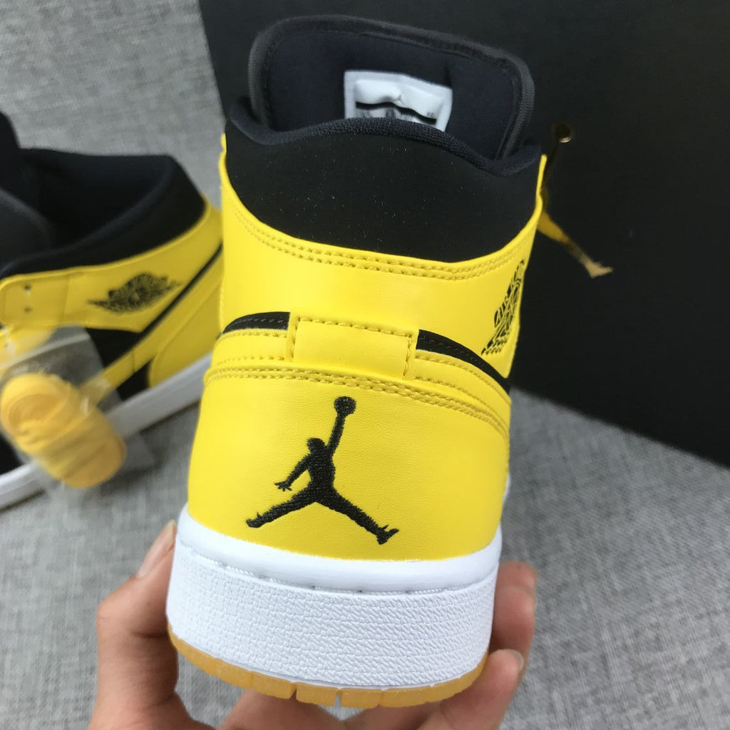 Air Jordan 1 Mid Sneakers in Black and Yellow - product image from the listing.