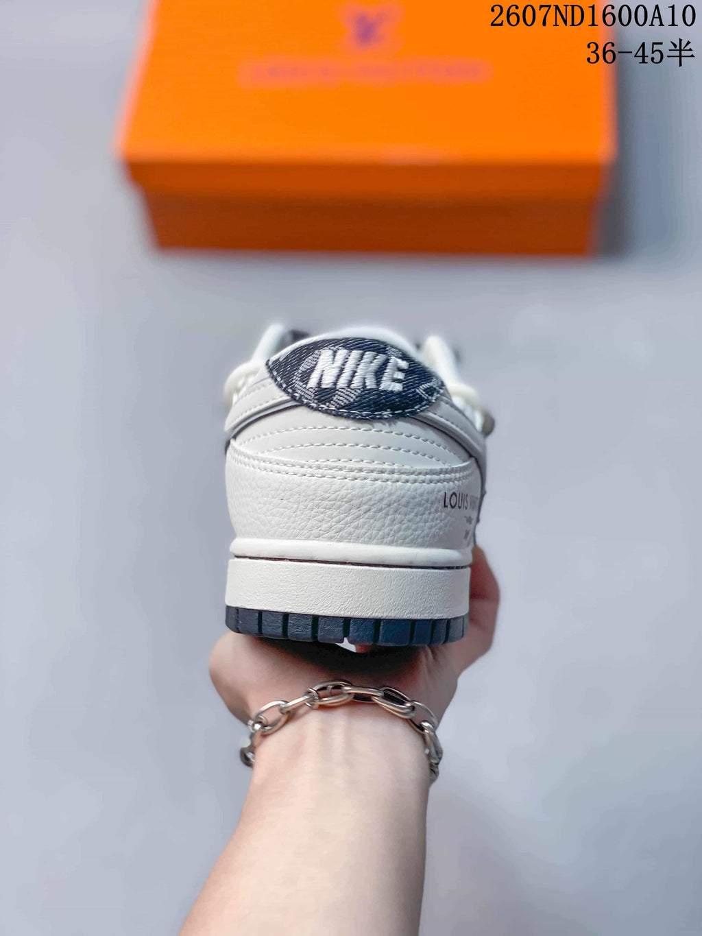 Nike SB Dunk Low Low-Top Sneakers in White and Navy - product image from the listing.