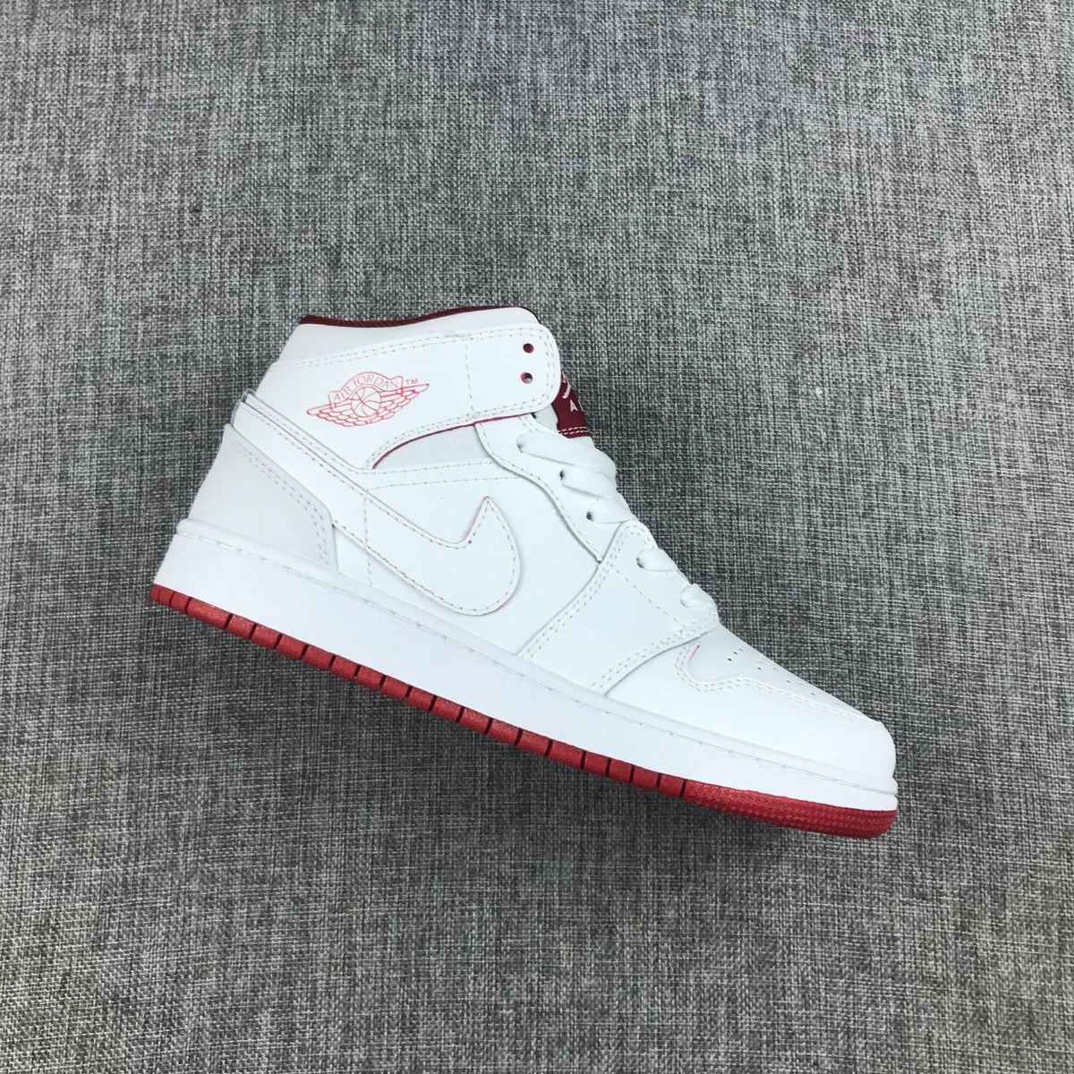 Air Jordan 1 Mid Sneakers in White and Red 554725-103 - product image from the listing.
