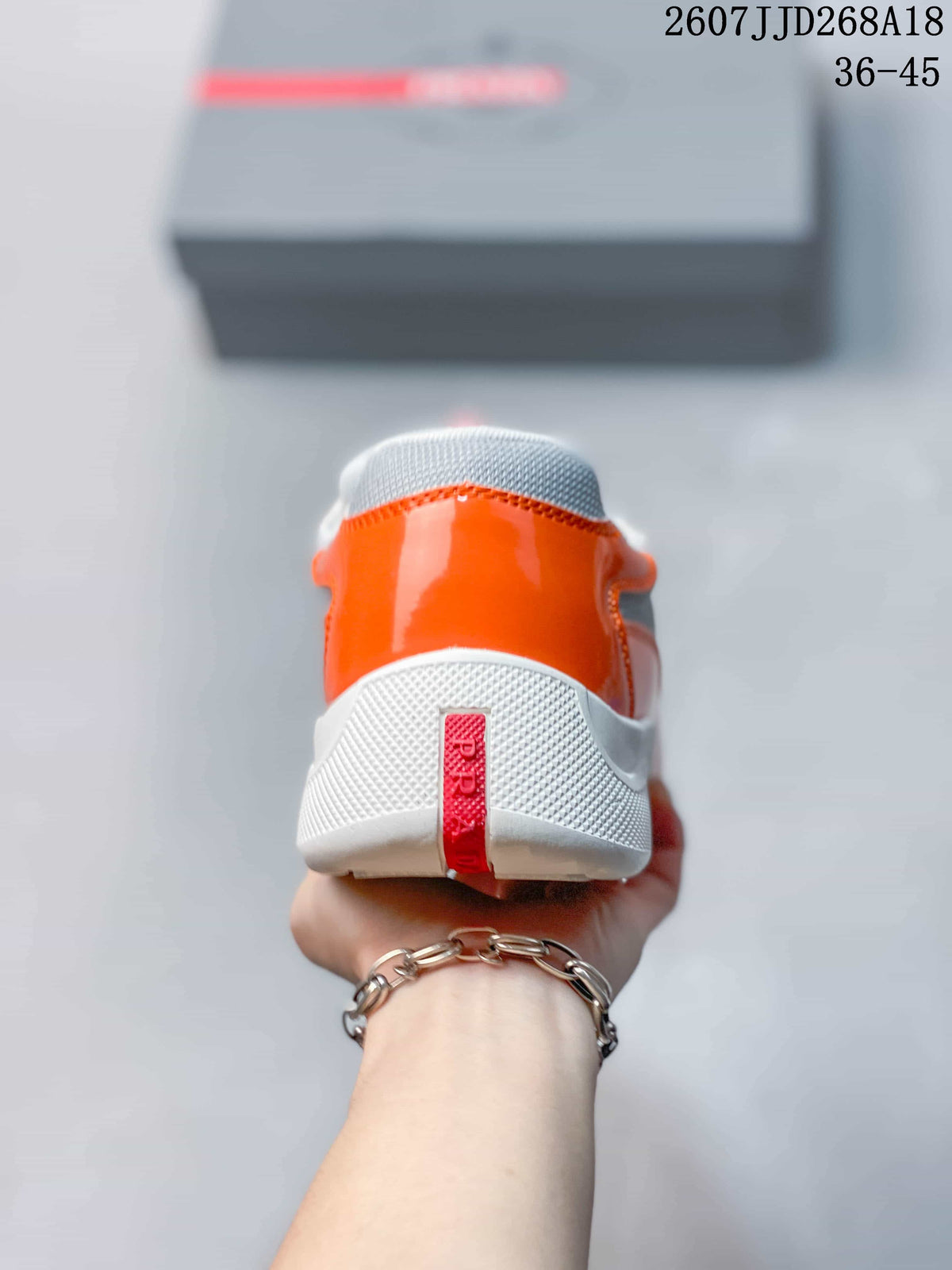 Prada America's Cup Orange Low-Cut Lace-Up Sneakers - product image from the listing.
